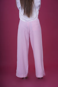 High Rise Side Slit Trousers - These trousers feature a flattering high-rise waist and chic side slits, adding a modern twist to a classic design. Crafted with comfort and contemporary fashion in mind, they offer a sleek and tailored fit that complements various occasions.